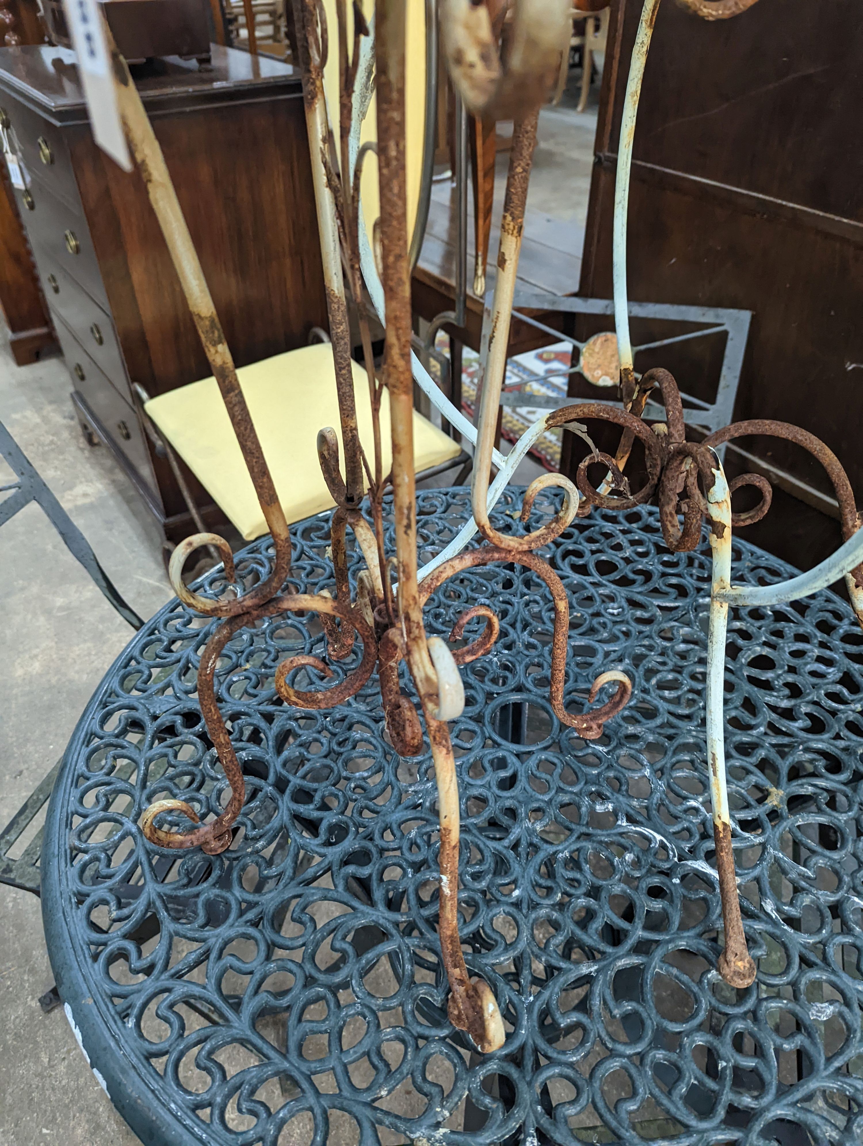 A painted wirework and wrought iron pot stand, height 79cm together with a similar circular table